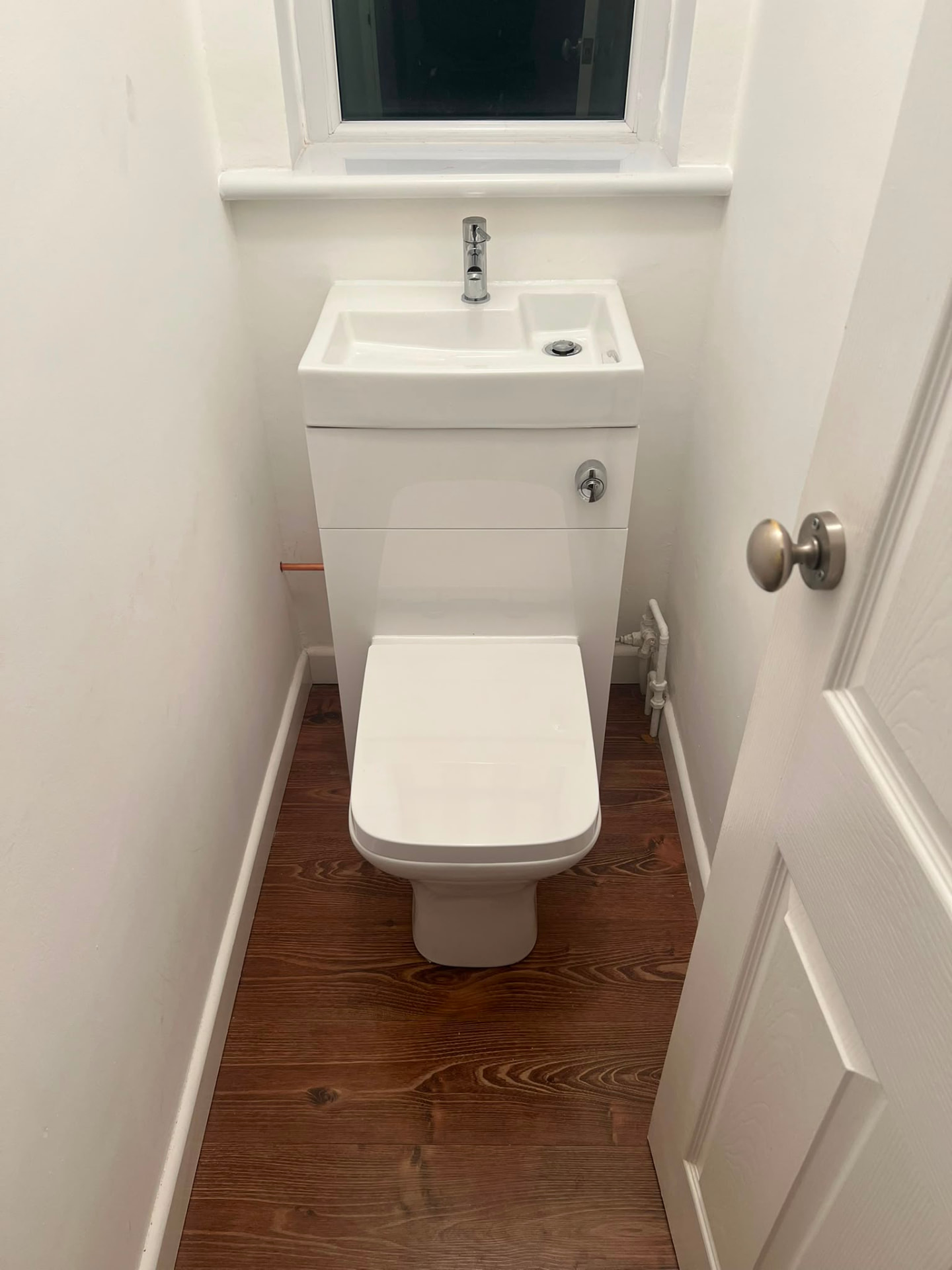 Cloakroom fit-out with compact toilet and basin vanity unit installed, fitted by Gas Safe registered engineers in Essex
